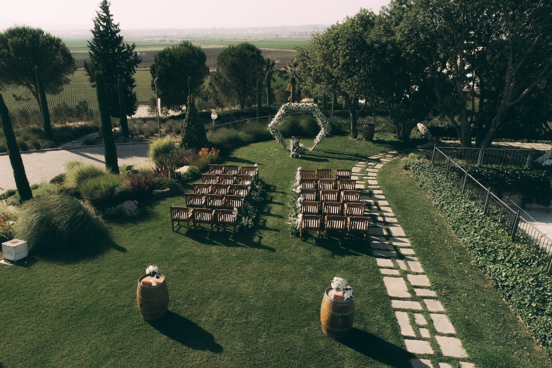 Garden wedding setting wooden chairs floral arch
