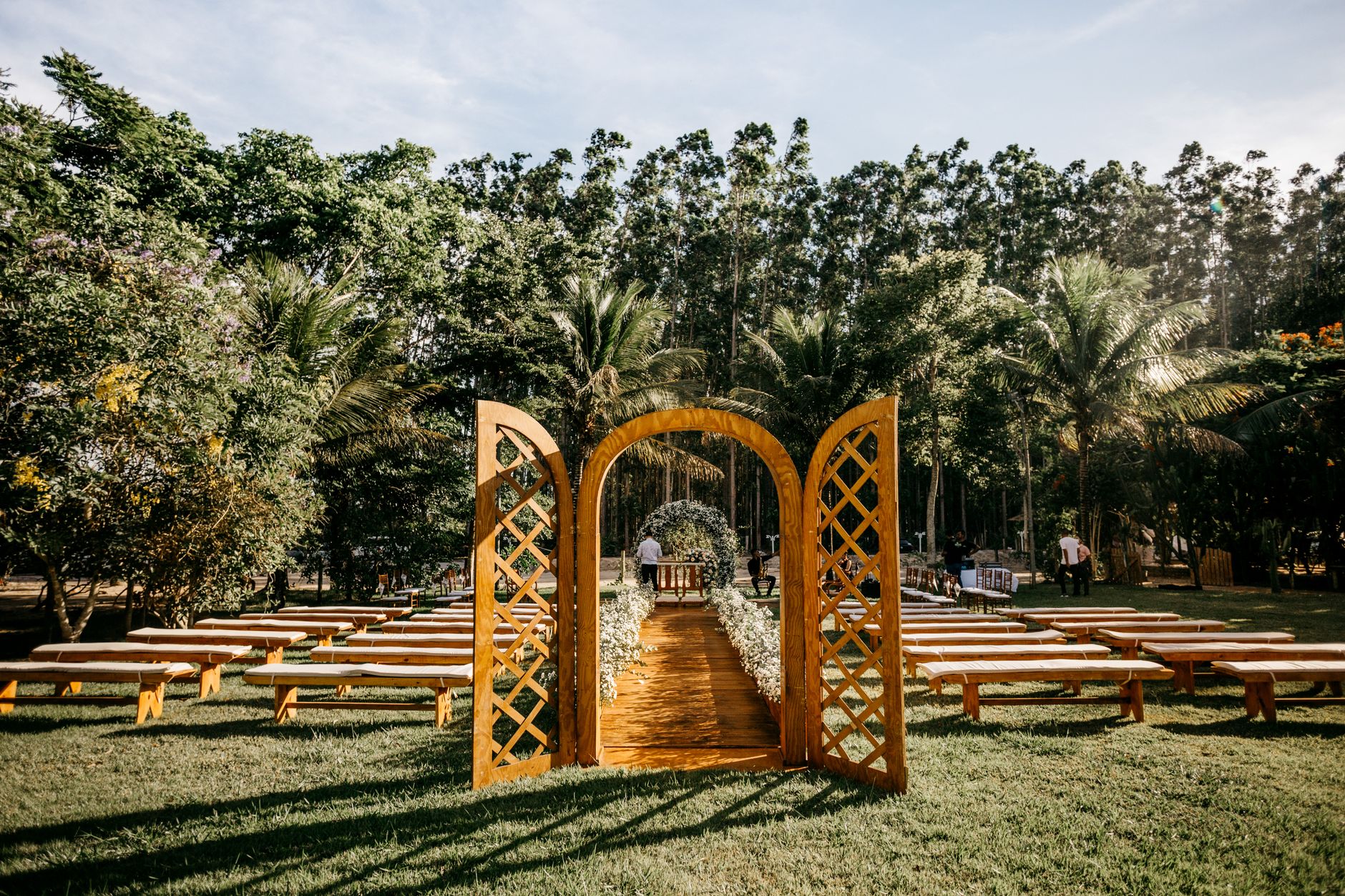 Arbor and rows of benches in lush park venue